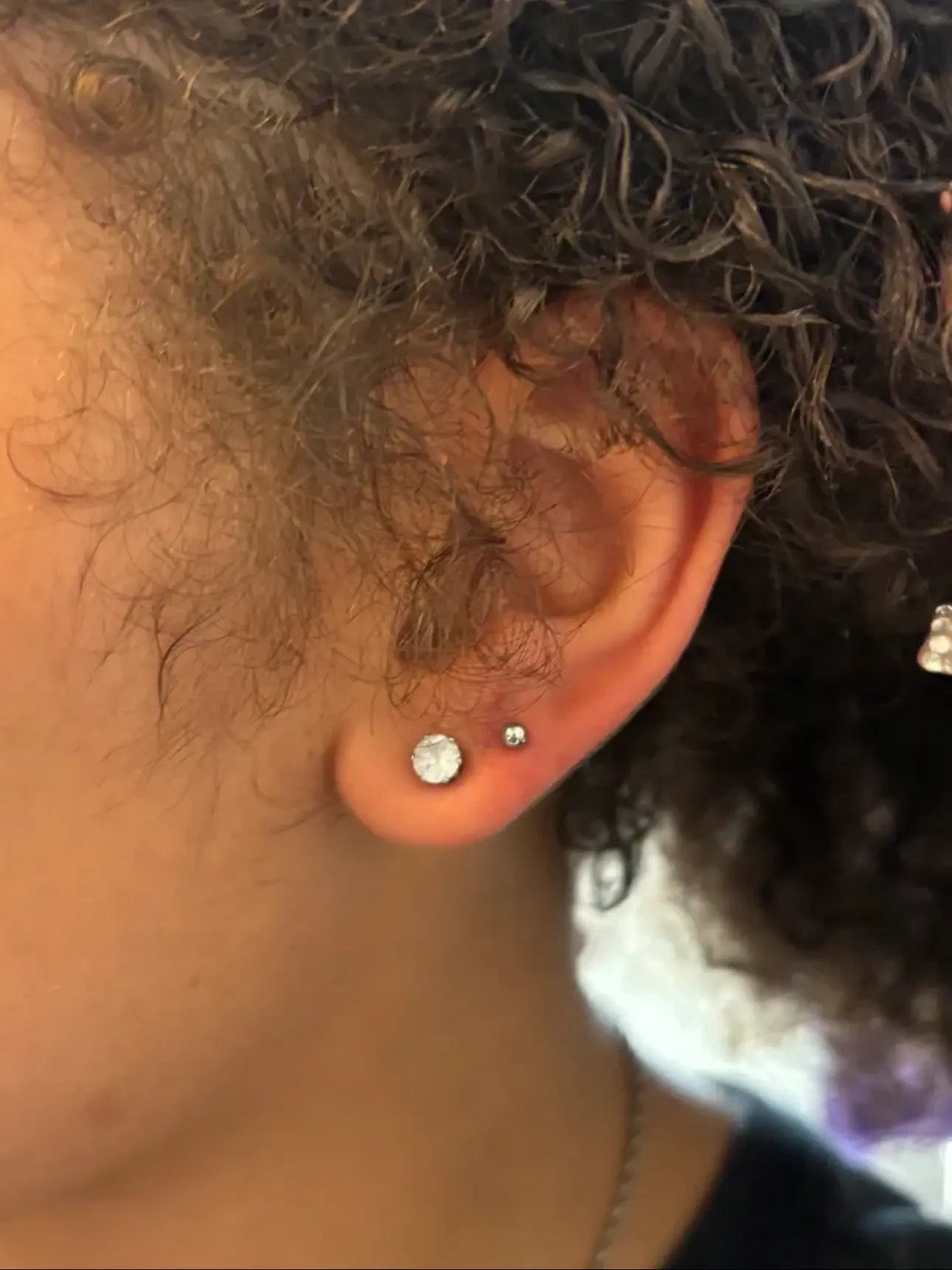 Second lobe piercing beside a crystal stud